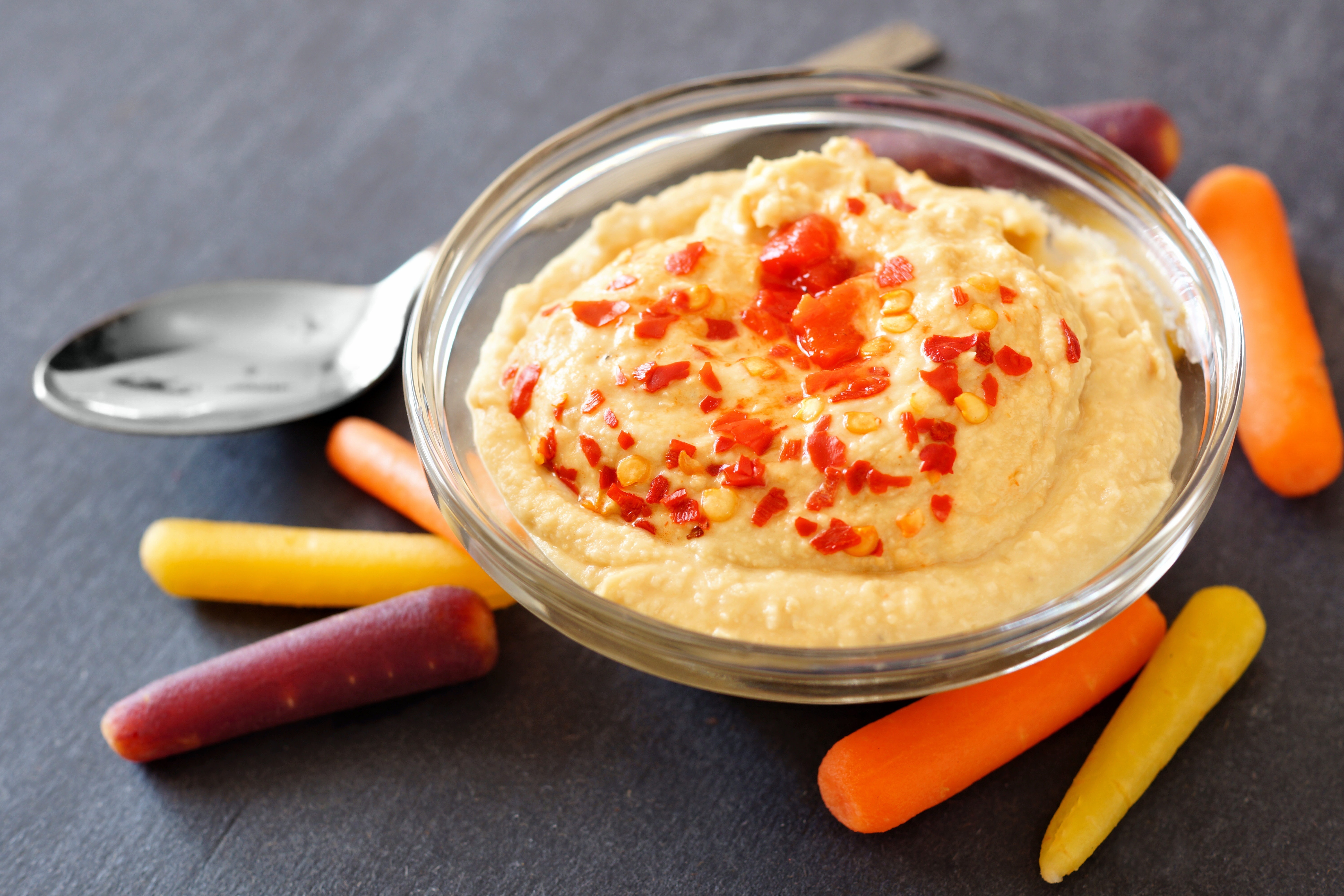 Spicy hummus dip and baby rainbow carrots 