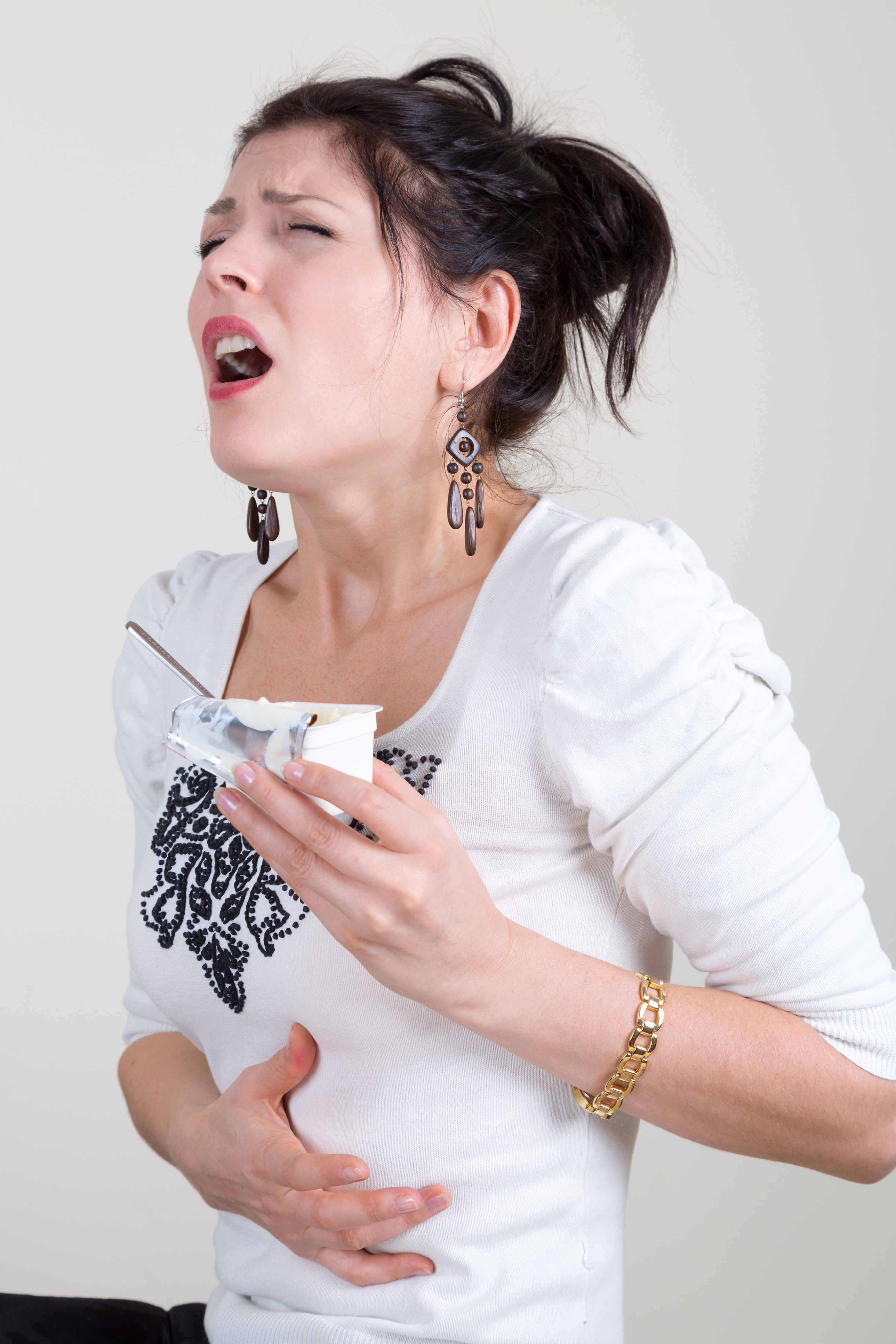 woman eating yogurt while on antibiotics