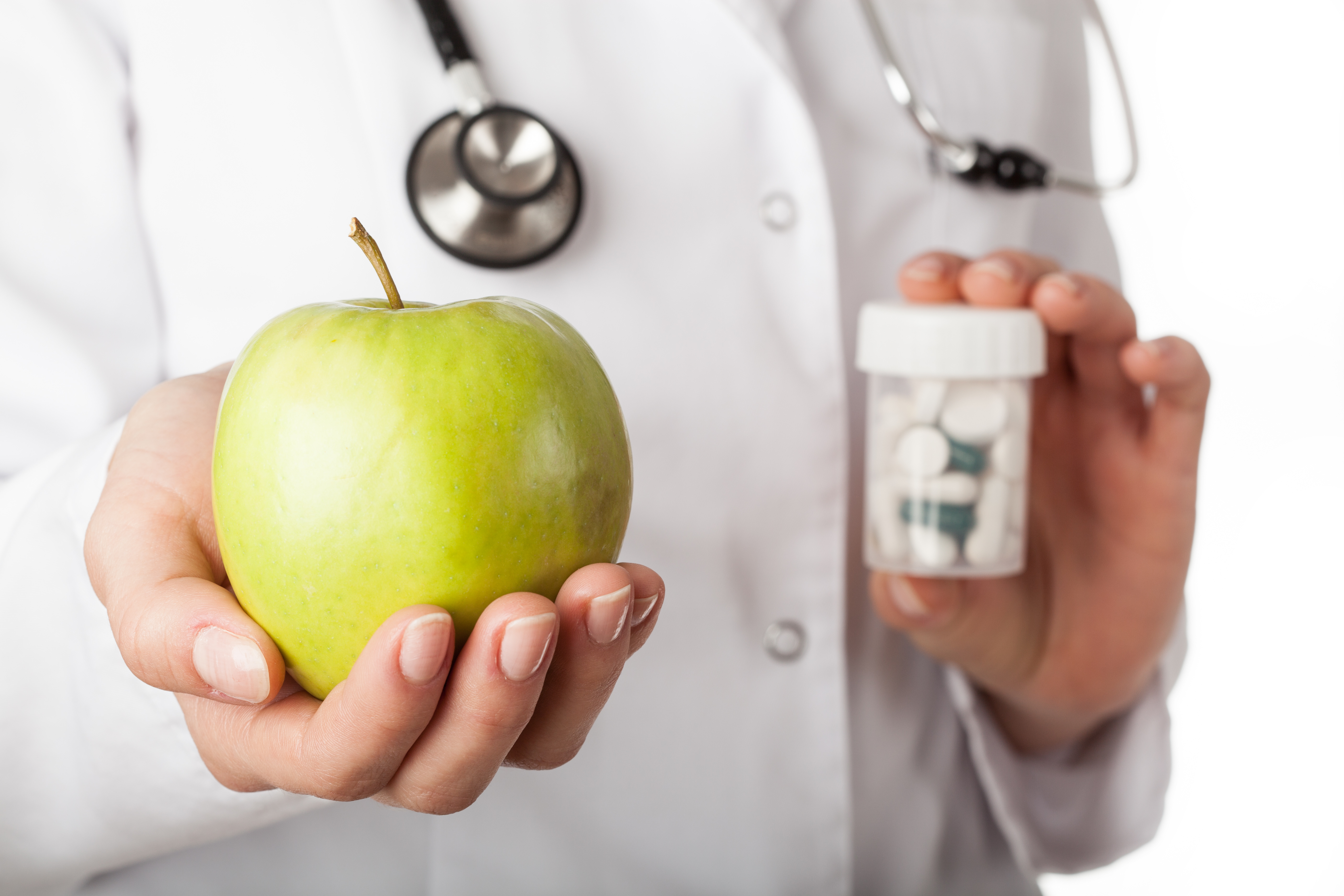 Doctor giving an apple instead of a drugs
